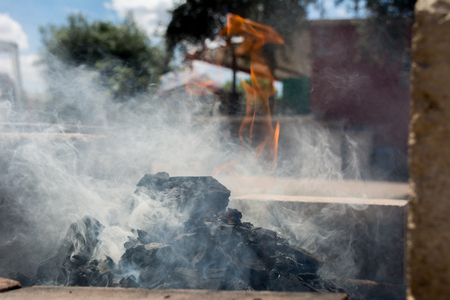 Horizontal View of a Barbecue Burning with Smog on Blur Background. Taranto, South of Italyの写真素材