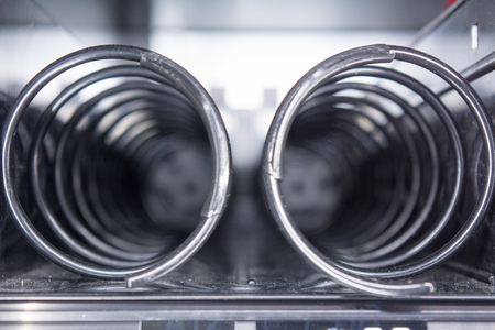 Horizontal View of Close Up of Empty Spirals inside the Snack Vending Machine on Blur Backgroundの写真素材