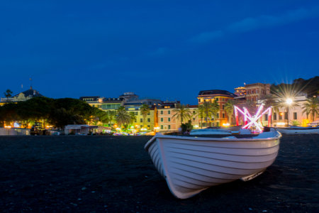 Small Boat on the Sand of the City of Sestri Levante after Sunset at Summer on Bly Sky Backgroundのeditorial素材