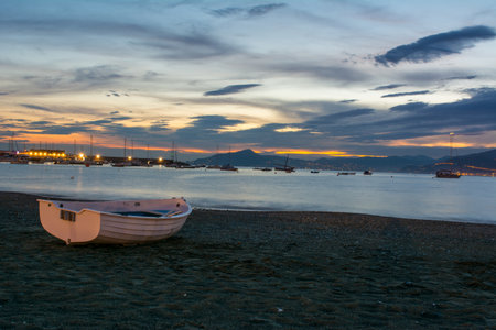Small Boat on the Sand of the City of Sestri Levante after Sunset at Summer on Bly Sky Backgroundのeditorial素材