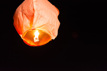 Chinese Flying Lantern Flying on Dark Backgroundの写真素材