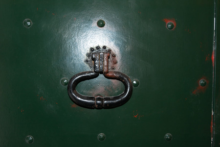 Close Up of an Old Clapper on an Old Green Painted Doorの写真素材