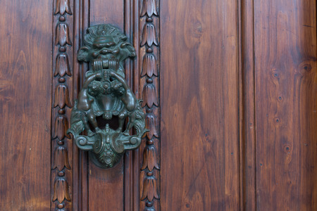 Old Door Clapper on Old Wooden Door Bacground. Copy Space.の写真素材