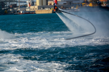 Horizontal View of Santa Claus on Flyboard on Blur Background. Taranto, Italyのeditorial素材