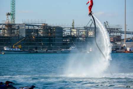 Horizontal View of Santa Claus on Flyboard on Blur Background. Taranto, Italyのeditorial素材