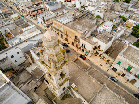 Aerial View of the Belltower of the Church of St. John Baptist in the Town of Sava, near Taranto, in the South of Italy on Partially Cloudy Sky Backgroundの写真素材