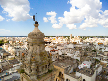 Aerial View of the Belltower of the Church of St. John Baptist in the Town of Sava, near Taranto, in the South of Italy on Partially Cloudy Sky Backgroundの写真素材