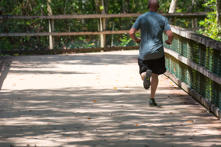 Man Running on Walkway in the Park in a Hot Day on Blur Background. Turkey Creek, Niceville, Floridaの写真素材