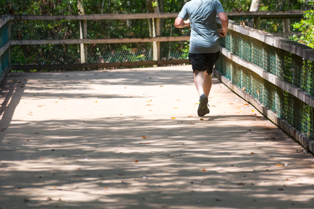 Man Running on Walkway in the Park in a Hot Day on Blur Background. Turkey Creek, Niceville, Floridaの写真素材