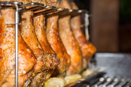 Close Up of Chicken Drumsticks covered by Seasoning Roasted in the Grill on Blur Backgroundの写真素材