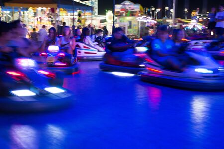 Close Up of Blurred Bumper Cars Running in the Night in a Luna Park in South of Italy on Blur Background