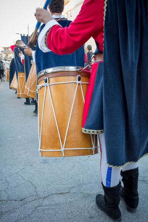 Close Up of Man Playing Drum at Medieval Village Festival on Blur Backgroundの写真素材