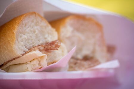 Close Up of Piece of Bread with Salami on Blurred Backgroundの写真素材
