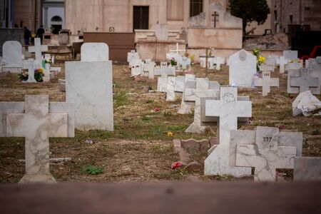 Tombs in a Field in the Day of Commemoration of the Dead in Italian Cemetery on Blurred Backgroundの写真素材