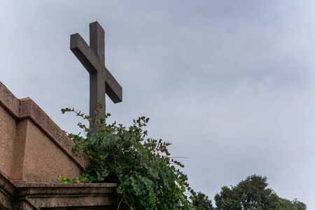 Christian Crux  in the Day of Commemoration of the Dead in Italian Cemetery on Blurred Backgroundの写真素材