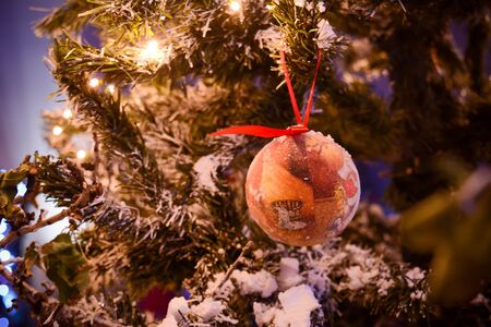 Christmas Decorations on a Christmas Tree on Blurred Backgroundの写真素材