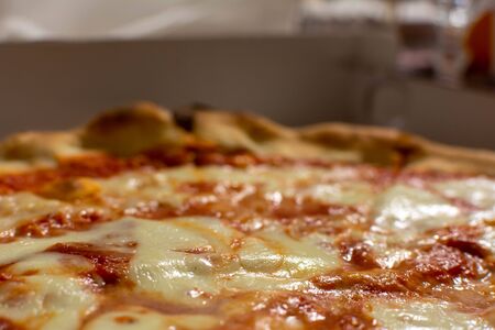 Close Up of Italian Pizza Margherita with Mozzarella and Tomato on Blurred Backgroundの写真素材