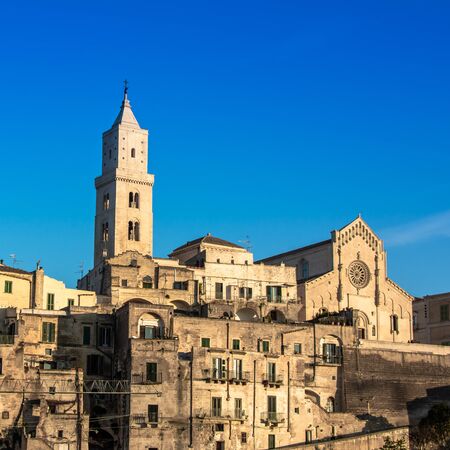 The Cathedral of Matera in the Middle of the Sassi di Matera on Blue Sky Backgroundの写真素材