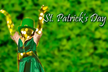 Silhouette of a girl that dress a green cap that dances  on Green Background fot saint patrick day. copy space.の写真素材