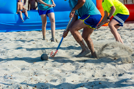 Guys Playing Beach Hokey on Official Competition in Summer on the Sand on Blurred Backgroundの写真素材