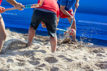 Guys Playing Beach Hokey on Official Competition in Summer on the Sand on Blurred Backgroundの写真素材