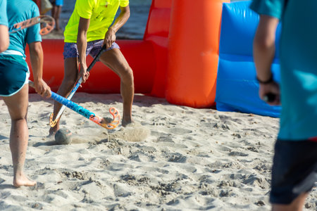 Guys Playing Beach Hokey on Official Competition in Summer on the Sand on Blurred Backgroundの写真素材