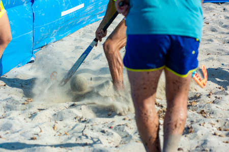 Guys Playing Beach Hokey on Official Competition in Summer on the Sand on Blurred Background