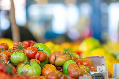 Close Up of Group of Fresh Tomatoes at the Italian market on Blurred Backgroundの写真素材