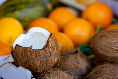 Close Up of a Group of Fresh Coconuts at the Italian Market on Blurred Background