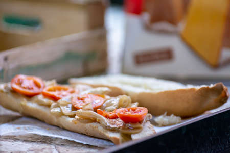 Close Up Close up of Baguette with Aubergines in Oil and Sliced Tomatoes at the Italian Market on Blurred Backgroundの写真素材