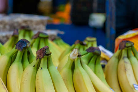 Close Up of a Group of Fresh Bananas at the Italian Market on Blurred Backgroundの写真素材