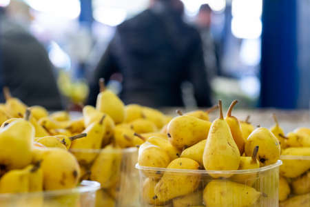 Close Up of Fresh Little Yellow Pears at the Italian Market on Blurred Backgroundの写真素材