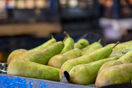 Close Up of Group of Fresh Pears at the Italian market on Blurred Backgroundの写真素材