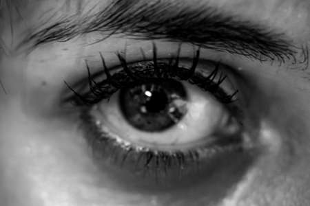 Close Up of Beautiful Eye Maked Up with Mascara in Gray Scale on Blurred Backgroundの写真素材