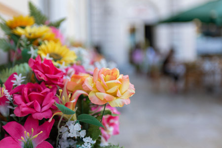 Close Up of Plastic Flowers decoration in the street on Blurred Backgroundの写真素材