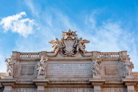 CParticular of the Decoration on the Top of the Trevi's Funtain in the Center of Rome on Partially Cloudy Sky Backgroundの写真素材