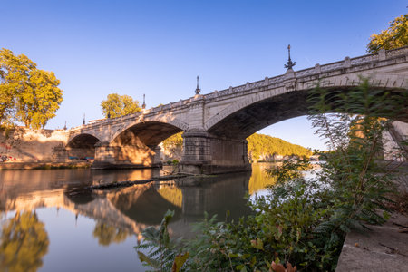 Long Exposition Shot of a Bridge on the Tevere River in the Center of Rome On Blurred Backgroundの写真素材