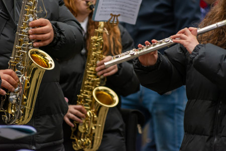 Musicians From A Popular Band Playing Traverse Flute and Saxophones During A Religious Procession On Blurred Backgroundの写真素材