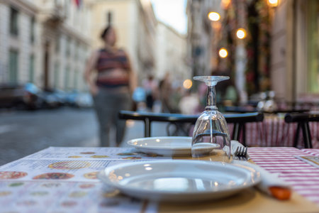 Close Up of a Table of a Restaurant in the Center of Rome on Blurred Tourist Silhouette Backgroundの写真素材