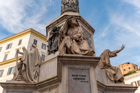 Detail of Decoration of the Column of Maria Immacolata, in the Center of ROme in proximity of Piazza Di Spagna on Partially Cloudy Sky Backgroundの写真素材