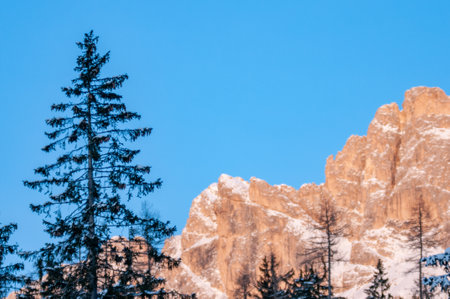 Italian Mountains Called Dolomiti Partially Covered By Snow in Winter at Sunset on Blurred Backgroundの写真素材