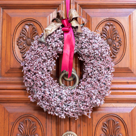 Christmas Decoration on a Beautiful Door in the Old Town of Martina Franca, Italy on Blurred Backgroundの写真素材