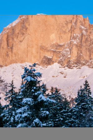 Italian Mountains Called Dolomiti Partially Covered By Snow in Winter at Sunset on Blurred Backgroundの写真素材
