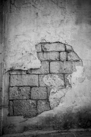 Broken Stone Wall In Greyscale In Martina Franca, Near Taranto, In The South Of Italy On Blurred Backgroundの写真素材
