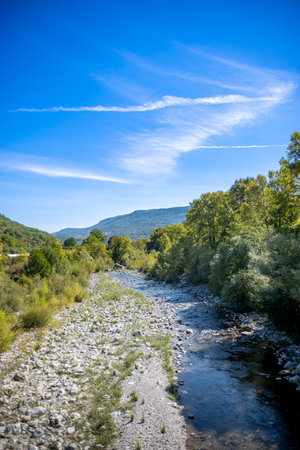 Small River in the Mountains in Italy in Summer on Blue Sky Backgroundの写真素材