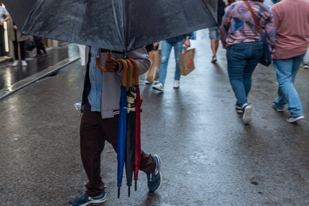 Selling Of Umbrellas On The Street In Italy During A Winter Raining Day On Blurred Background