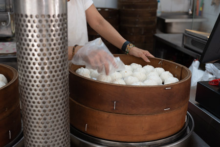 Large Tray Of Steamed Bread After Being Baked In A Store In Chinatown In Singapore On Blurred Backgroundの写真素材