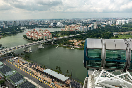 Wallpaper Panoramic View Of The City Of Singapore Taken By The Panoramic Wheel In A Cloudy Day On Blurred Backgroundの写真素材