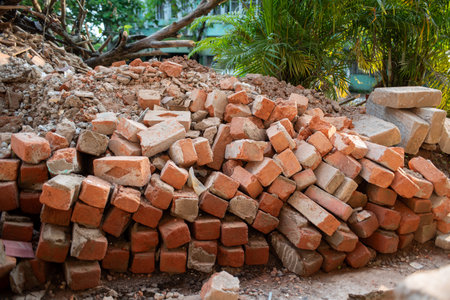 Pile Of Red Bricks During Building Construction on Blurred Background