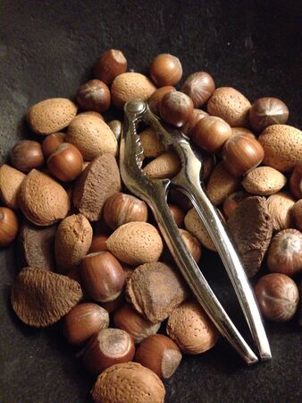 Nuts in bowl with silver nut cracker